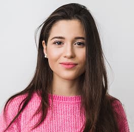 Beautiful women with long dark hair and pink sweater