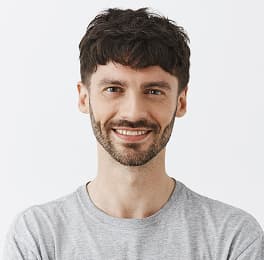 Handsome man with brown curly hair and big smile on his mouth